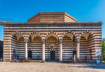 Facade of old building against blue sky