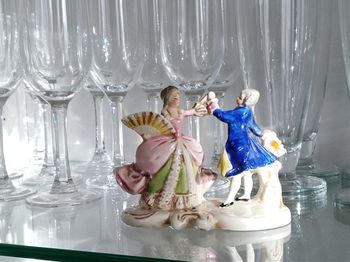 Happy girl with ice cream in glass on table