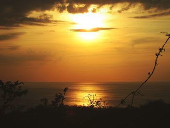 Scenic view of sea against romantic sky at sunset