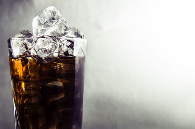 Close-up of alcohol cocktail against colored background