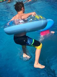 Rear view of boy in swimming pool