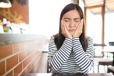 Portrait of young woman with eyes closed