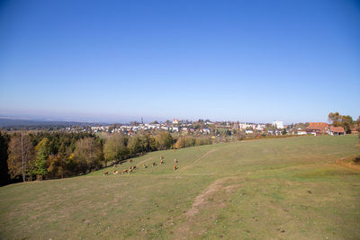 Panoramic shot of townscape against clear blue sky