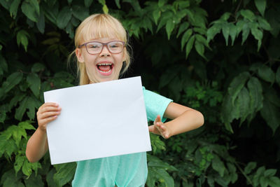 Portrait of young woman holding paper