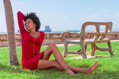 Portrait of woman sitting on grass