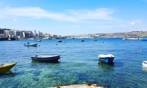 Boats moored in swimming pool against sky