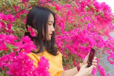 Portrait of young woman using mobile phone