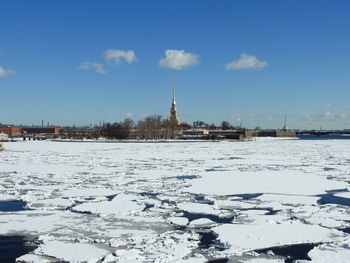 Snow covered buildings in city