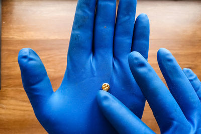 Close-up of hand on blue table