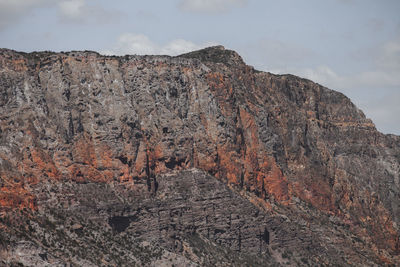 Low angle view of rocky mountains against sky