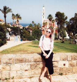 Portrait of young woman against built structure