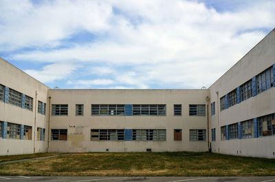 Exterior of abandoned naval air station against sky