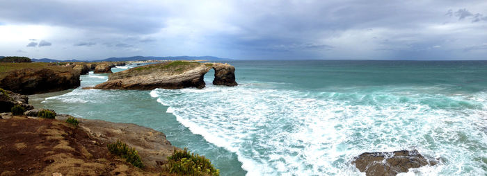 Scenic view of sea against cloudy sky