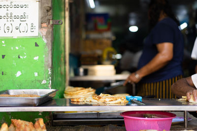 Midsection of woman preparing food in restaurant