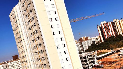 Low angle view of buildings against clear blue sky