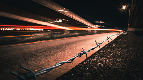 Illuminated light trails on road at night