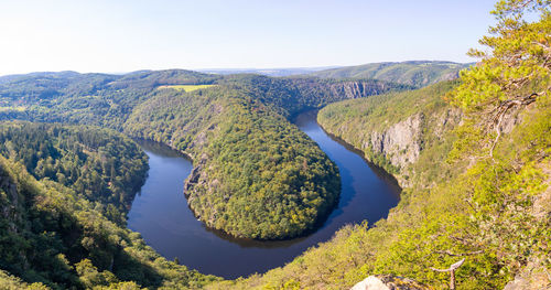 Scenic view of river and mountains against clear sky