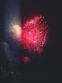 Low angle view of firework display at night