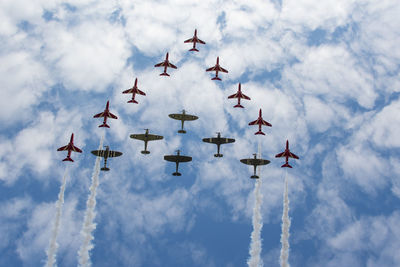 Low angle view of airshow against sky