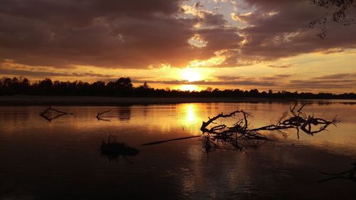 Scenic view of lake against orange sky