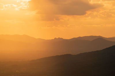 Scenic view of silhouette mountains against sky during sunset