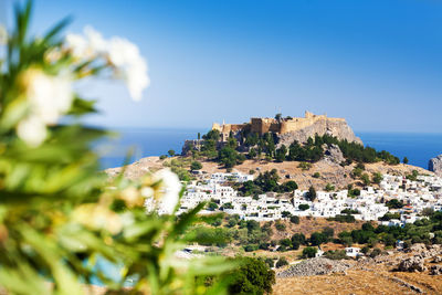 Townscape by sea against clear sky