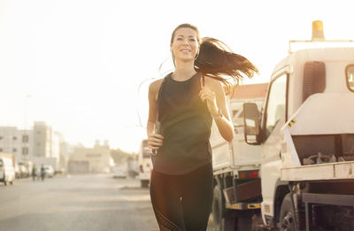 Woman listening music while running on road