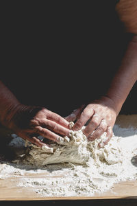 Close-up of person preparing food on table