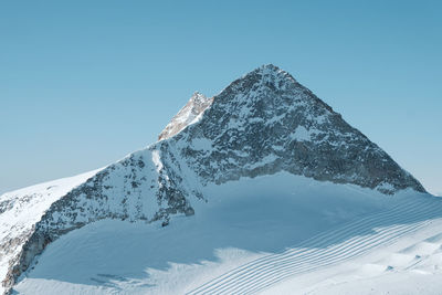 Scenic view of snowcapped mountain against clear blue sky