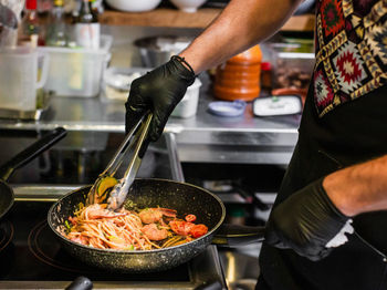 Midsection of man preparing food in kitchen