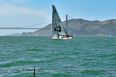 Ship sailing on sea against sky