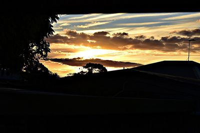 Silhouette trees against sky during sunset