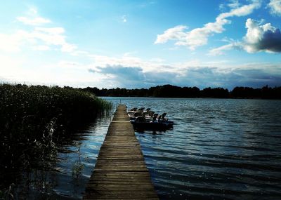 Pier over lake against sky