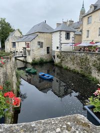 Canal amidst houses and buildings in city