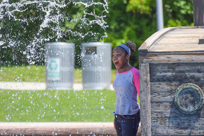 Girl being splashed with water