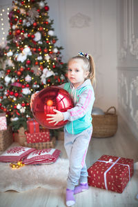 Cute girl with christmas tree at home