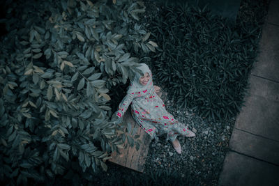 High angle view of girl on plant