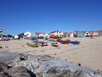 Scenic view of beach against clear blue sky