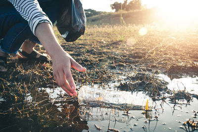 Low section of woman on field