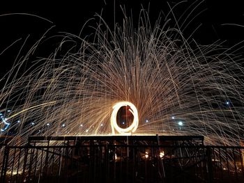 Low angle view of fireworks against sky at night