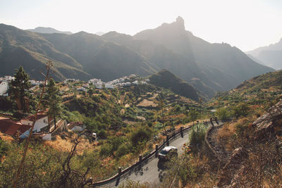 High angle view of river and mountains against sky