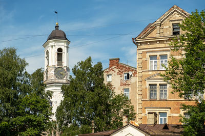 Vyborg, russia. july 02, 2002. city view of residential buildings and medieval clock tower