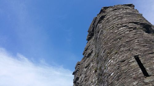 Low angle view of old ruin against blue sky