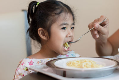 Portrait of cute girl eating food