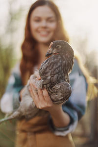 Portrait of woman holding bird