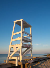 Lifeguard hut on beach against cloudy sky