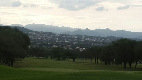 Scenic view of mountains against cloudy sky