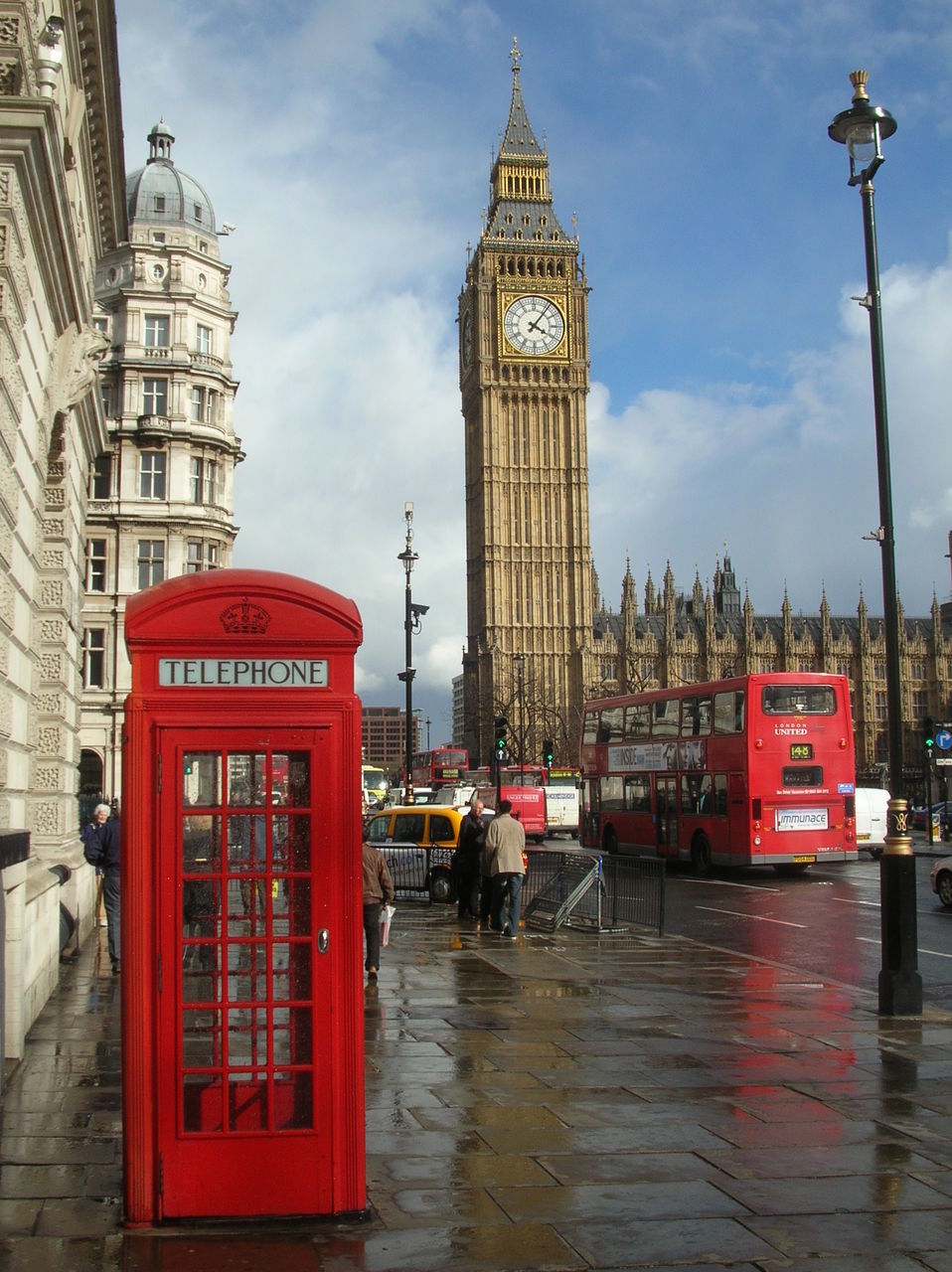 architecture, building exterior, built structure, tower, city, sky, travel destinations, communication, famous place, red, tall - high, clock tower, capital cities, tourism, travel, international landmark, street, text, cloud - sky, city life