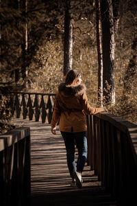 Rear view of woman on footbridge