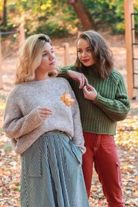 Two young girls standing in the park 